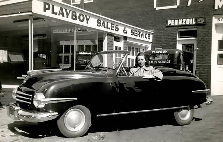 Playboy car in front of service and sale building