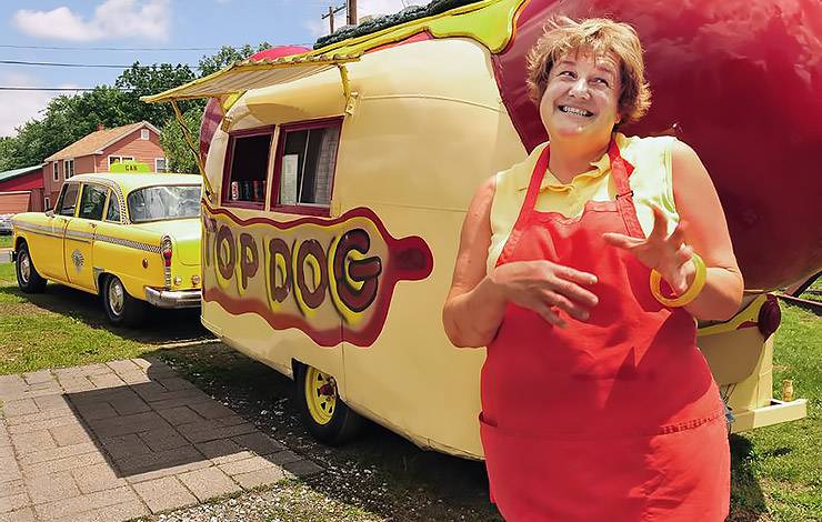 Andrea Spaulding in front of Top Dog trailer hot dog stand on Route 66