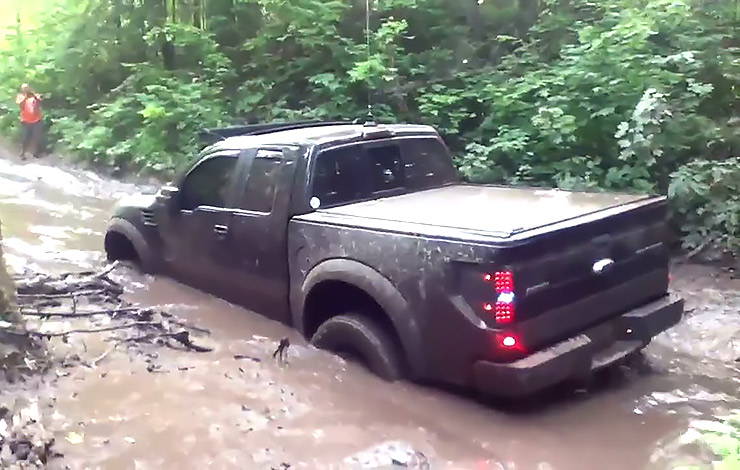 Ford Raptor stuck into deep muddy pond